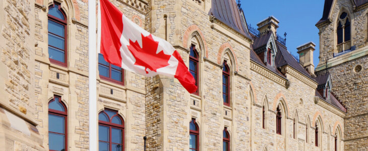 Canadian flag at half-mast in front of the Canadian parliament building.