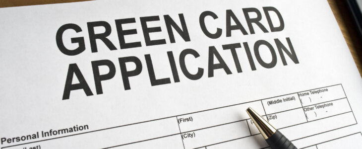 Application for a green card on a desk top.